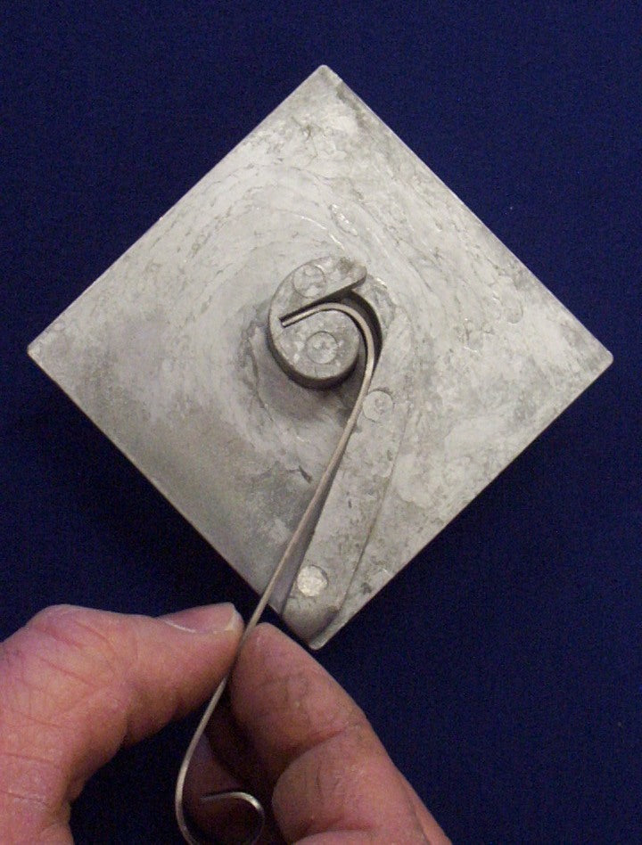 Kosy Creations BJ2 metal wrapping around and once it clears you drop the metal down onto the plate to continue making scroll