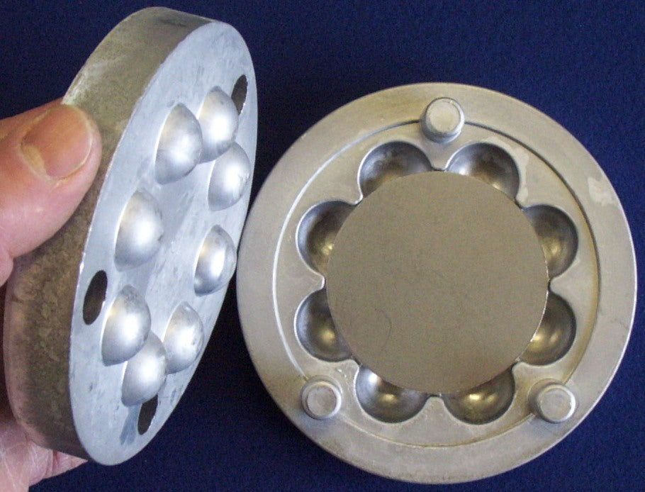 Step 3 in fluting a tray. Blank flat plain disc (our DP2 or DP2withHole) sits in female part of FD1 set as male part is being placed over the female part containing the DP2 disc part.
