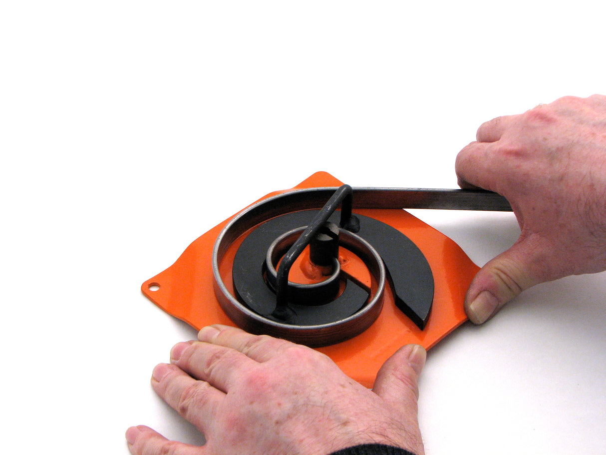 metal is drawn around Metalcraft MK2/2H Scroll Bender by hand. After the 1st segment, the starting handle is no longer used and scroll completed by hand.