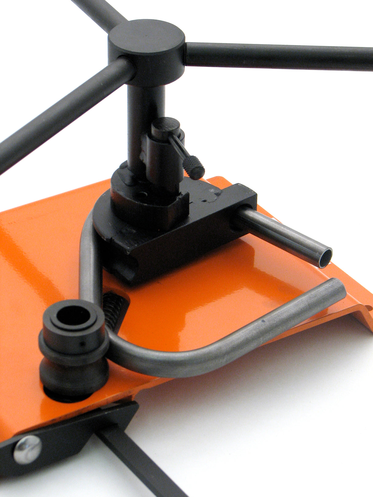 3/4" O.D. tubing being bent on the Metalcraft Scroll Bender MK3/3 Former. Once end of tube fed into the bending component, rotate handles to create bend in tube up to 180 degrees.