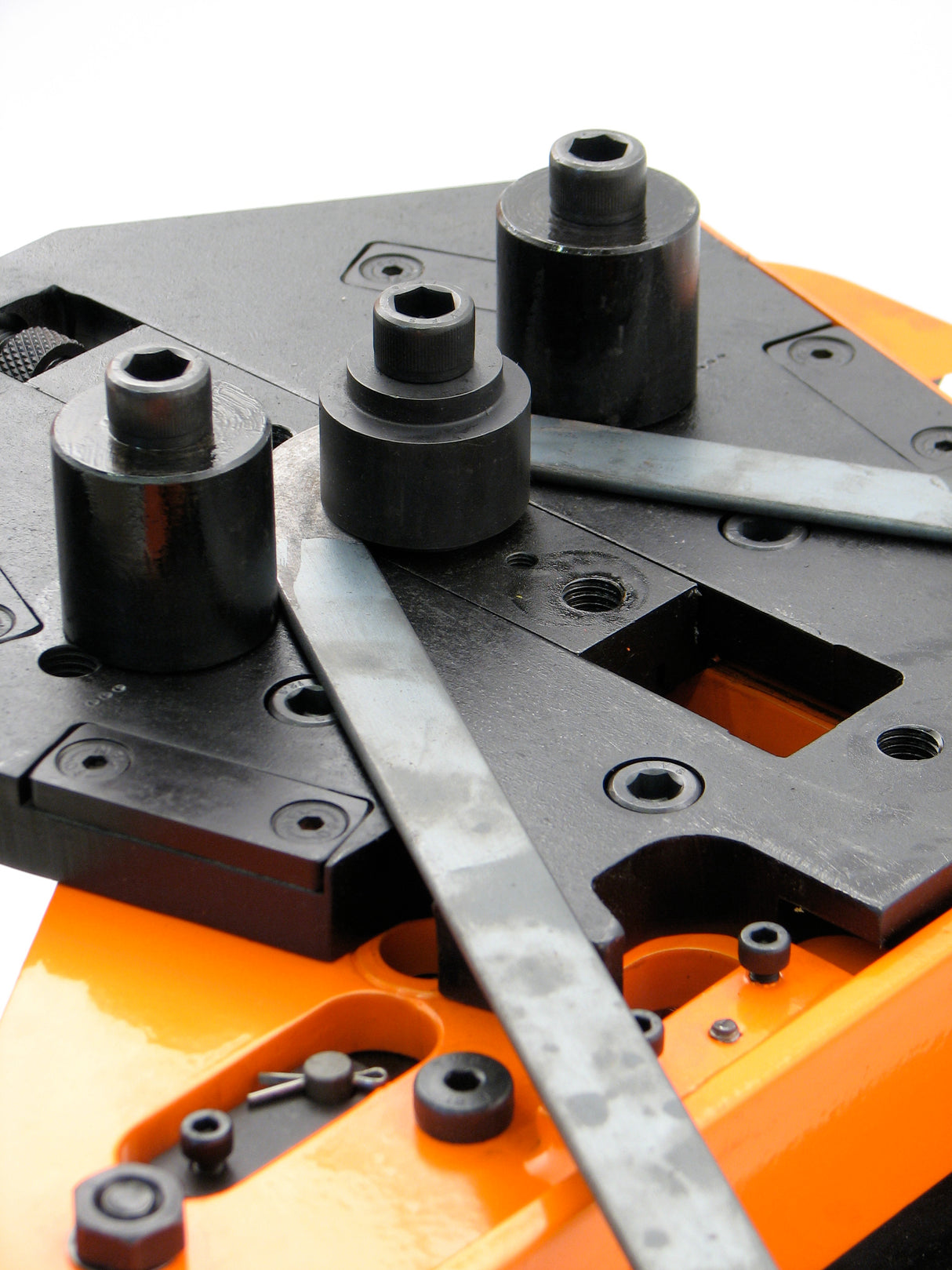 Flat mild steel strip held down by roller