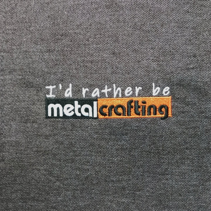 Closeup of I'd rather be metalcrafting" logo on Dark Gray T-shirt