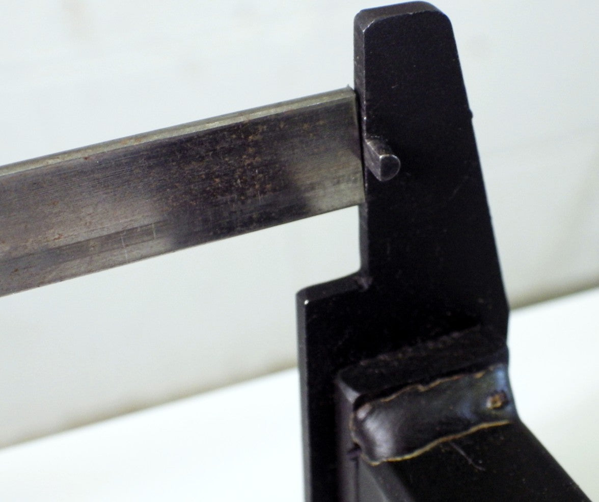 Using measuring device on the Metalcraft Practical Punch Shear Tool to repeatedly punch holes a set distance from end of metal.