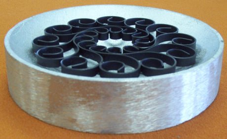 Flat ring section placed in female part of dishing die, with welds down.  Welds can be facing up or down depending on the project.