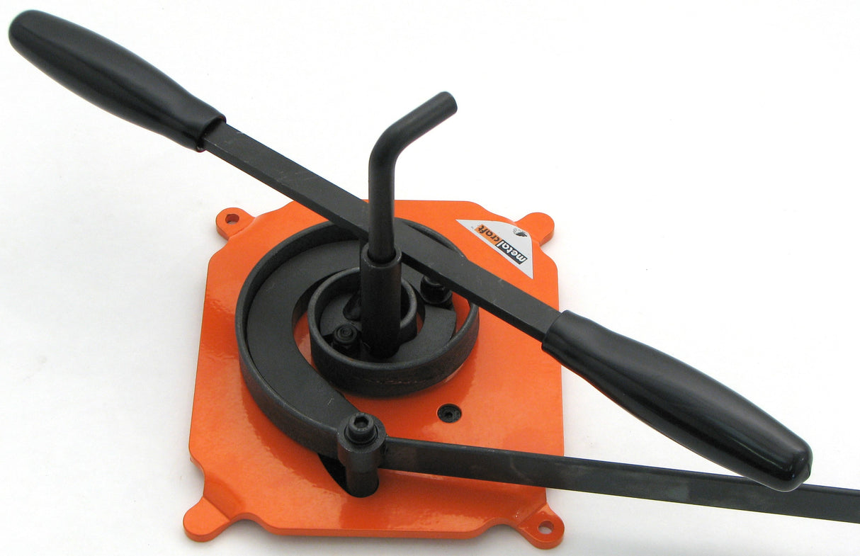 Metalcraft MK2/3 Scroll Bender.  Shown with piece of flat metal steel strip formed in a scroll.  Does same size metal as the MK2/2H Scroll Bender BUT metal is drawn in as you turn the handle vs. on the MK2/2H the metal is hand drawn around.