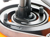 Extreme closeup of scroll segments with flat metal steel strip wrapped around segments on the Metalcraft Scroll Bender MK3/3 Former