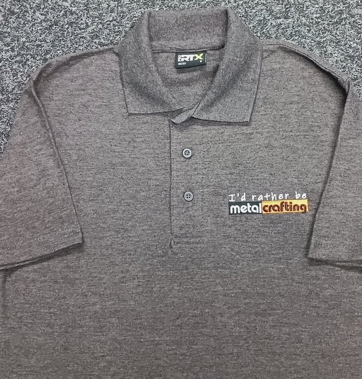 Closeup showing Dark Gray T-shirt embroidered with "I'd rather be metalcrafting"