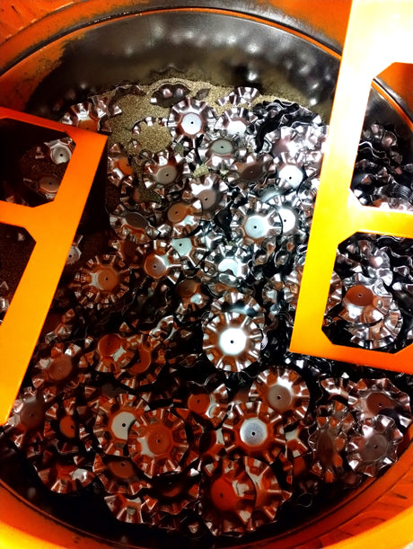 T7 Candle Tray in cement mixer after being tumbled several hours.  From this mixer they go into another mixer and sprayed with a protectant.  Not all stampings get tumbled but the ones that do, this is the process.