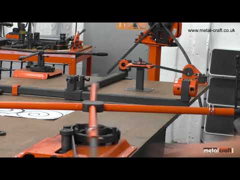 Video showing how to make a scroll using the Metalcraft Scroll Bender MK3/4 Former using 2"w x  1/4" thickness flat metal steel strip.  In background one can see the Metalcraft Tool Bench with variety of tools on top and the XL5+ Power Bender mounted on Option 1 Pedestal.